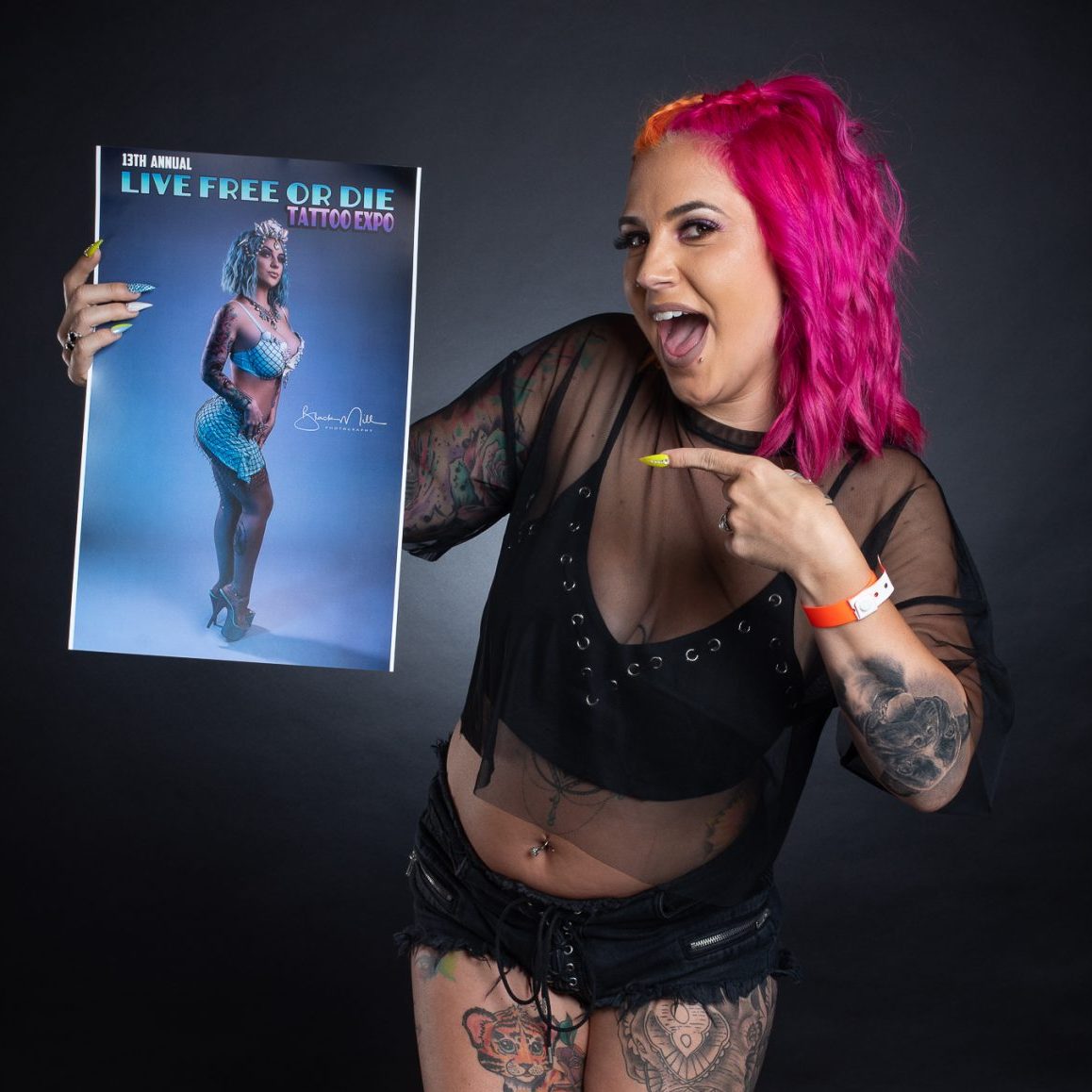 Photo of a girl holding the tattoo expo guidebook